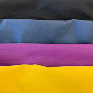 Taslan fabric is durable, water-resistant, and quick-drying, commonly used in outdoor and activewear for its performance properties and rugged appeal.